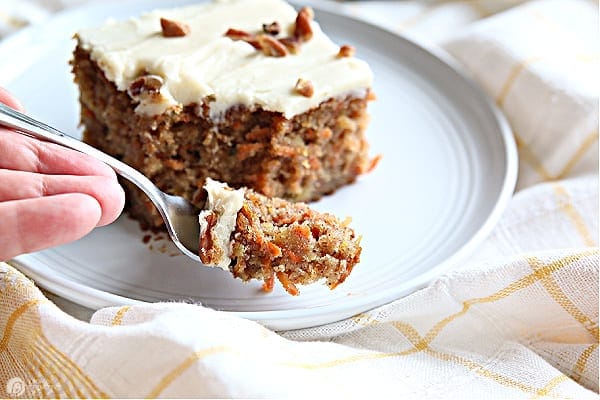 Carrot cake bite on a fork.