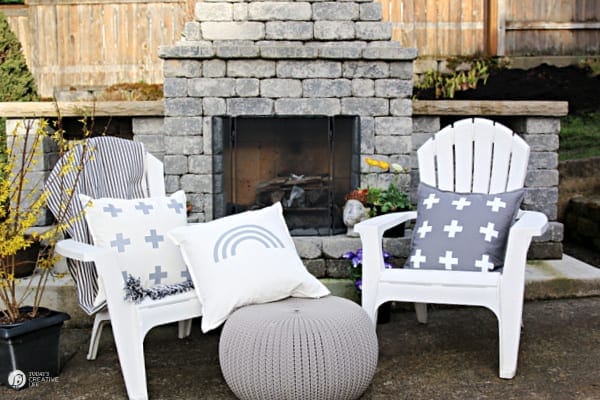 White outdoor chairs with decorative pillows in grey and white