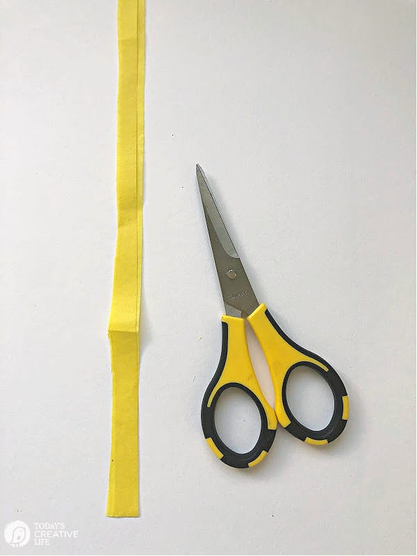 Yellow Tissue paper strip with craft scissors