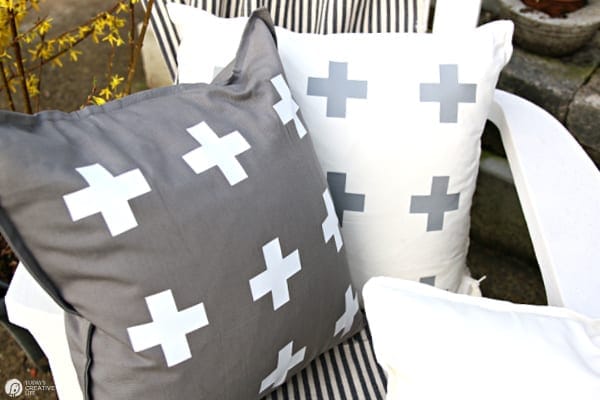 DIY Patio Ideas with pillows. One grey pillow with white designs. One white pillow with grey designs. Cricut Maker Iron-on Ideas