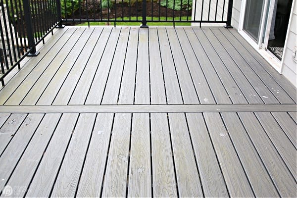 a composite deck with green moss build up.