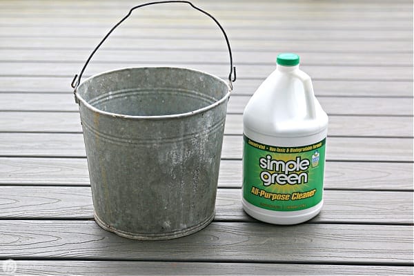 Tin Bucket and a Gallon of Simple Green Cleaner on a deck