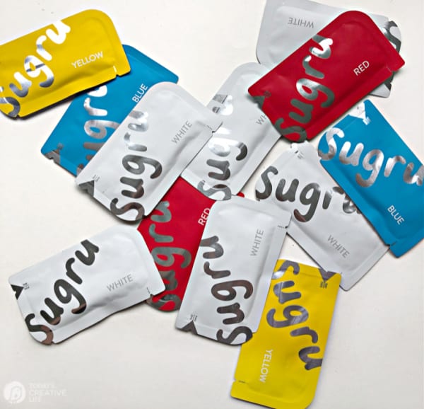 packets of Sugru Moldable Glue in red, white, blue and yellow.
