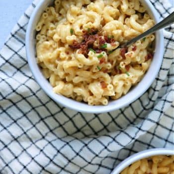 Mac and Cheese with bacon and chives in white bowls.