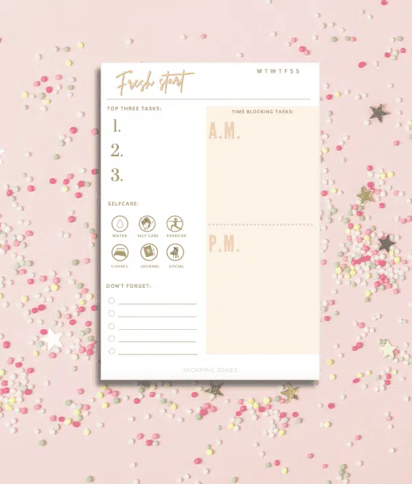 Daily planner notepad on a pink sparkle background