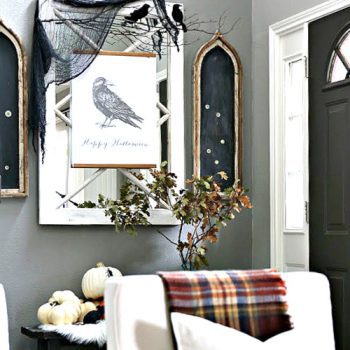 DIY Halloween Decor Ideas | Halloween entry way decorated with a printable crow poster and pumpkins