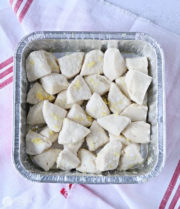 Quartered biscuits in a tin baking pan. Recipe for frozen blueberries.