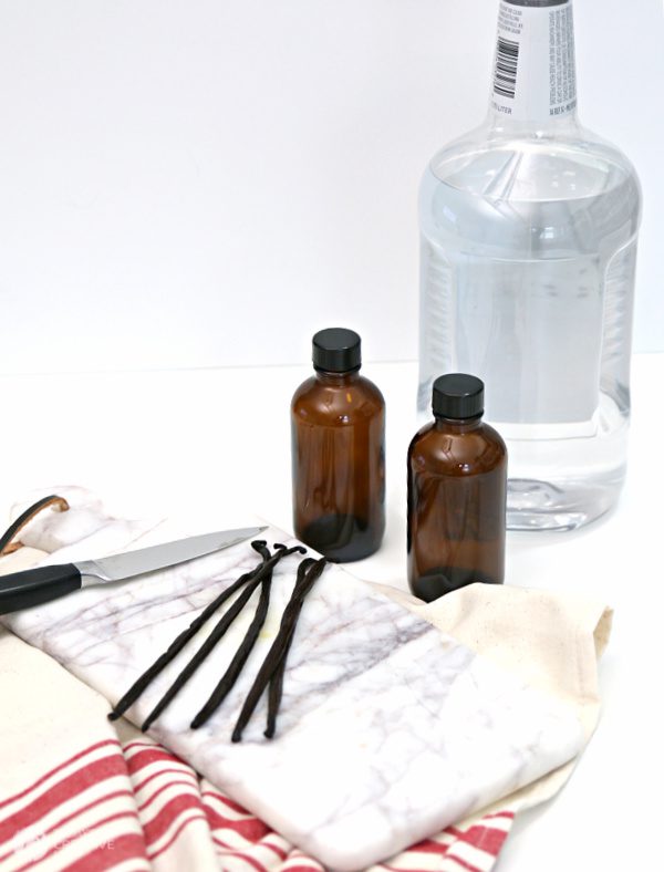 Recipe for Homemade Vanilla Extract | brown bottles, vanilla beans and a bottle of vodka.