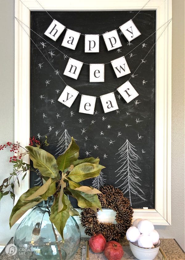 Printable Happy New Year Banner hung on black chalkboard