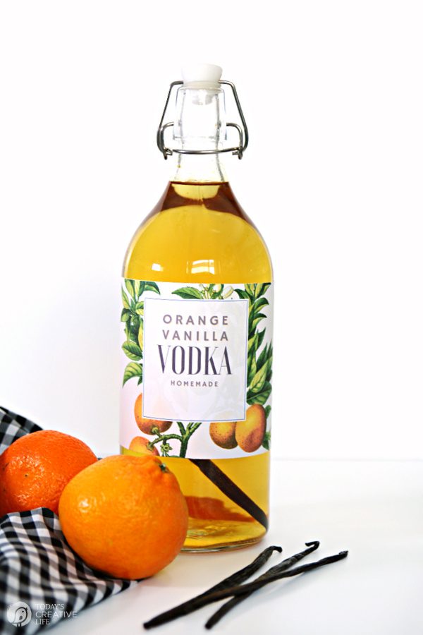 Clear glass bottle with amber colored orange vanilla infused vodka