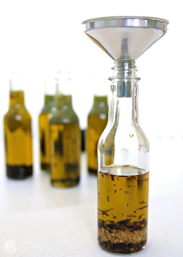 bottles filled with olive oil and herbs