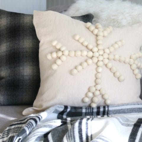 Winter decorative DIY snowflake pillow on sofa