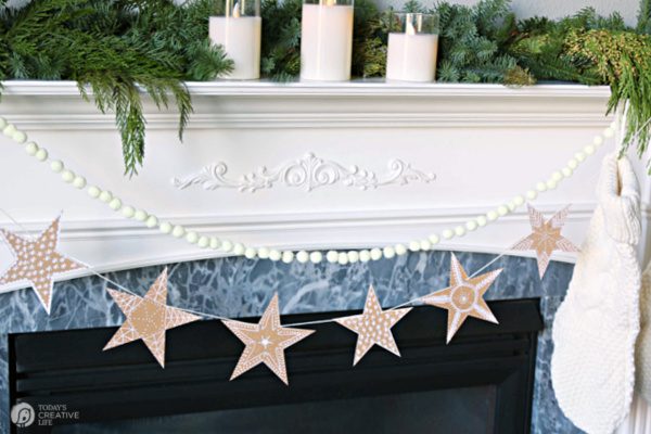 Gingerbread Star Garland hanging from a fireplace