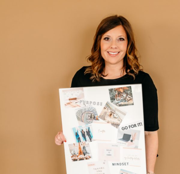 woman holding her completed vision board