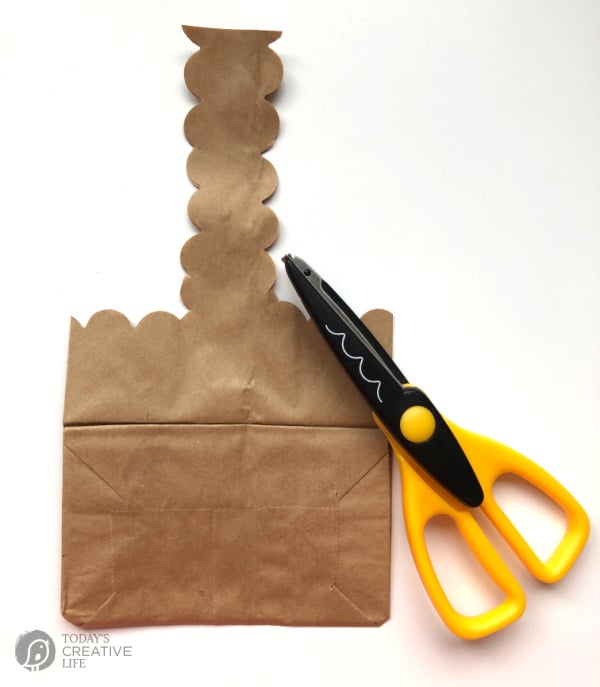 paper bag Easter Basket. Shaped craft scissors and cut paper bag with scallop cut shapes.