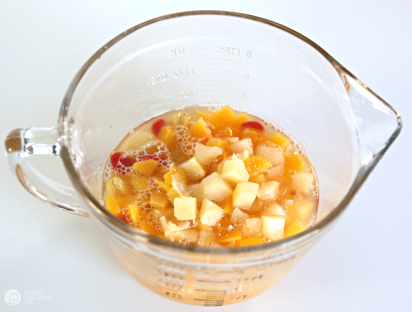 Glass clear bowl with fruit cocktail inside.