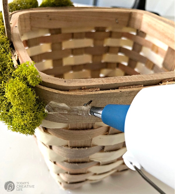 Easter Basket Idea \ adding glue to the side of a basket to add moss to after.