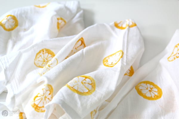 DIY Lemon Stamped Tea Towels laying on a table.