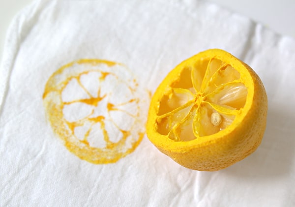 Lemon cut in half & stamped on a white tea towel