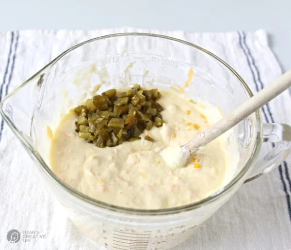 Corn Jalapeno Bread - mixing bowl with batter and mixing in diced jalapenos.