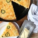 recipe for jalapeno cornbread in a skillet. Sliced triangle ready to serve.