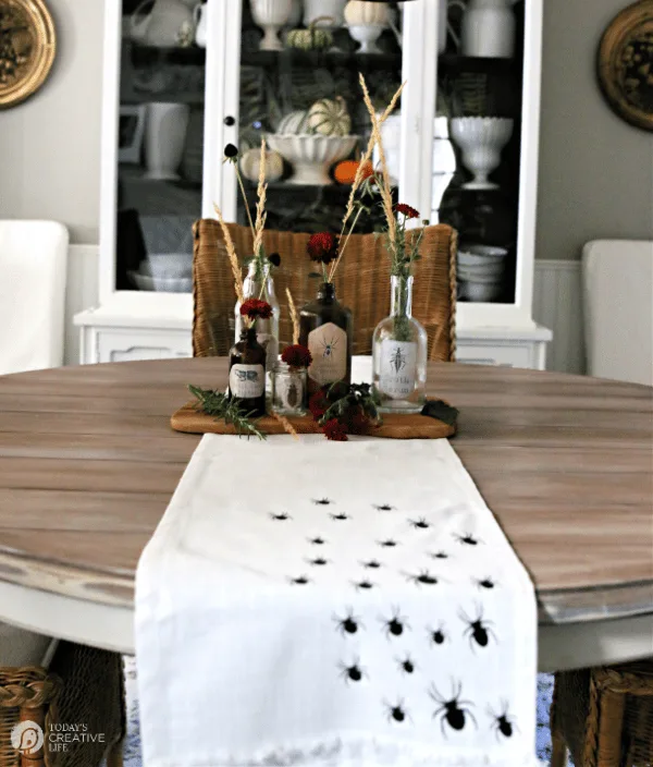 Dining table decorated for Halloween with Halloween Apothecary Jars