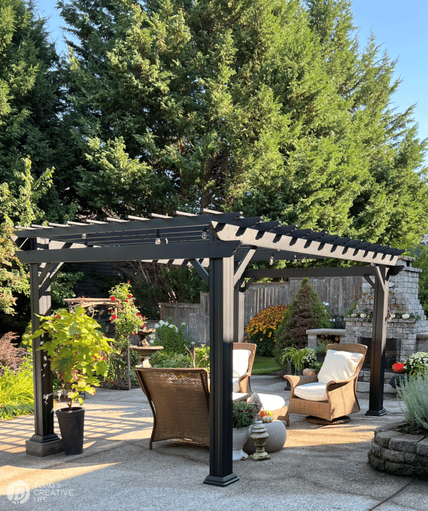 Pergola built from Pergola kits from Backyard Discovery. Black metal pergola in the backyard