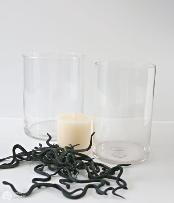 Glass vases, plastic black snakes and a candle for DIY Halloween Centerpiece