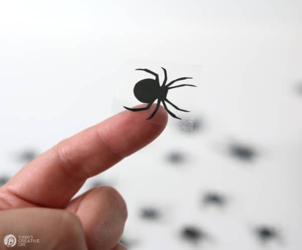 Vinyl black spider on finger tip
