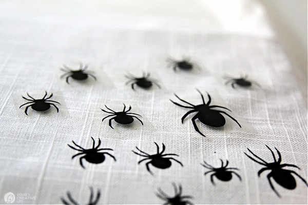 Spiders placed on the table runner to be ironed on. DIY Halloween Decor