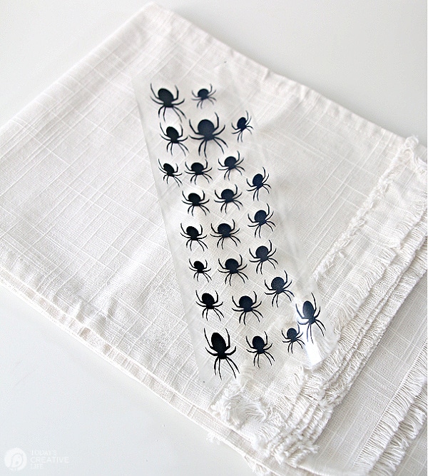 White table cloth with black vinyl spiders