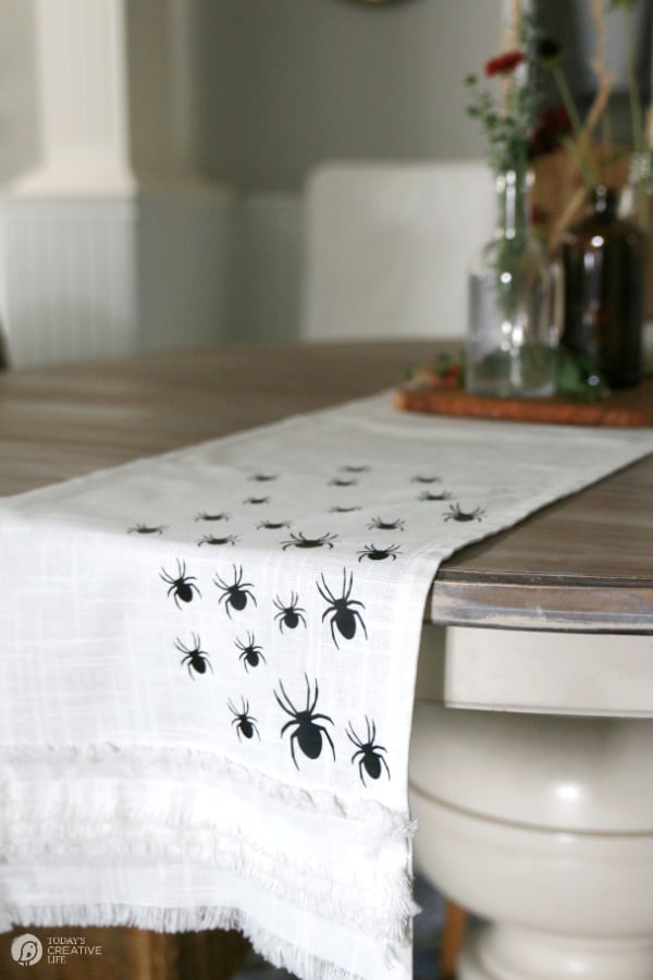 Table runner with black spiders on the table.