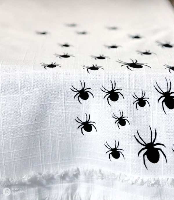White table cloth with black vinyl spiders