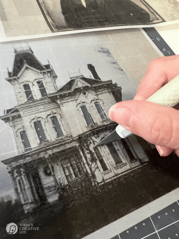 cutting windows from photo with a craft knife.