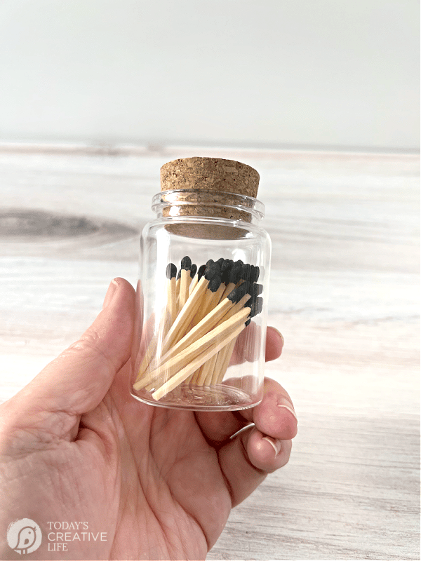 Small bottle with a cork top filled with wooden matches.