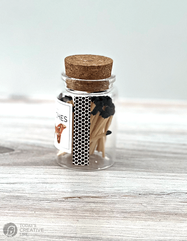 small glass bottle with wood matches and strike paper.