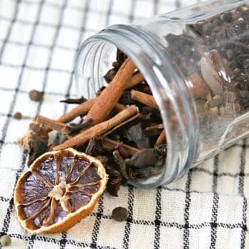 jar tipped with spilled spices for apple cider