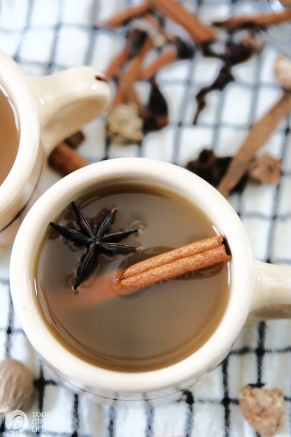 mug with spiced cider, garnished with a cinnamon stick and star anise
