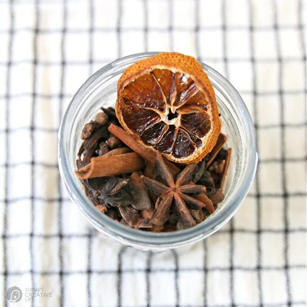 looking down into a jar of spices for apple cider.