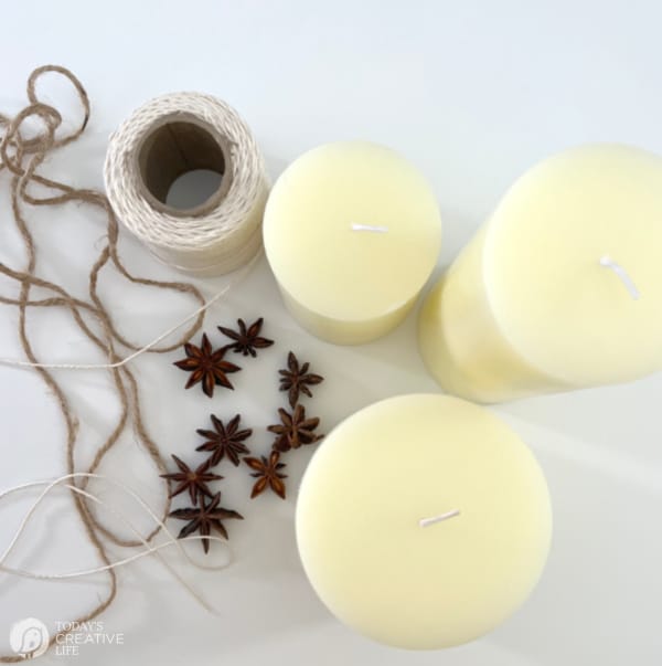 Supplies for making Rustic holiday candles. Pillar candles, star anise seed and string.
