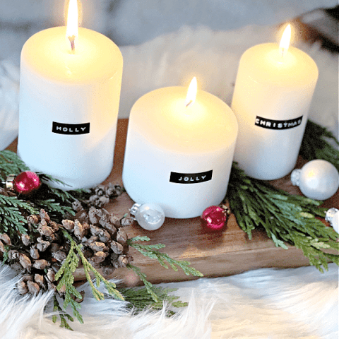 3 white candles with black labels from a punch letter label maker for Christmas decor with candles