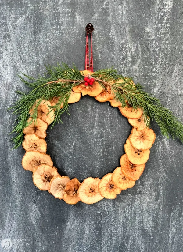 Dried apple wreath with cedar greens and red ribbon