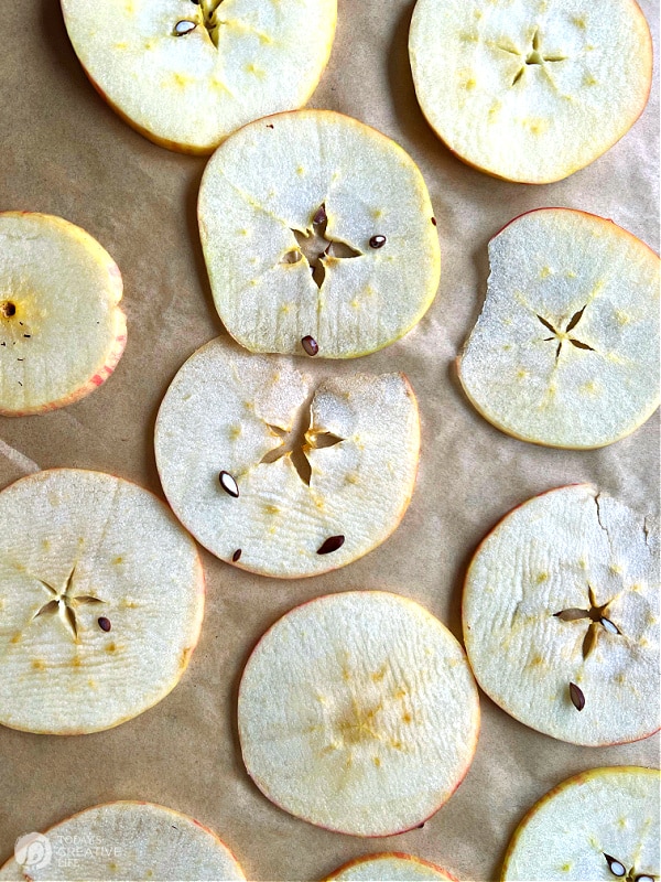Sliced apples on a baking sheet.