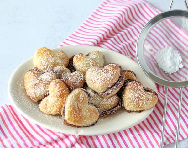 Plate of puff pastry heart sandwiches