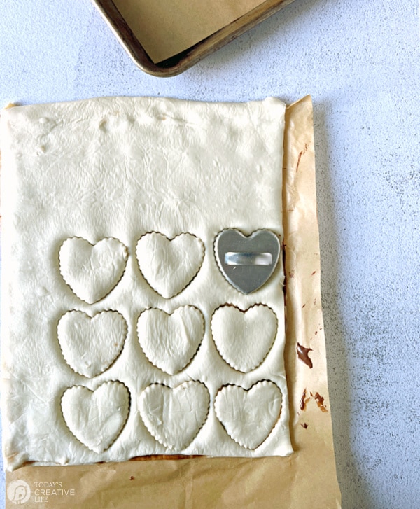 Heart shapes cut with cookie cutter on puff pastry. Filling for puff pastry can be sweet or savory.