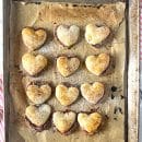 Puff pastry hearts baked golden brown on baking sheet