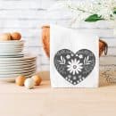 dish towel with grey heart in a kitchen setting