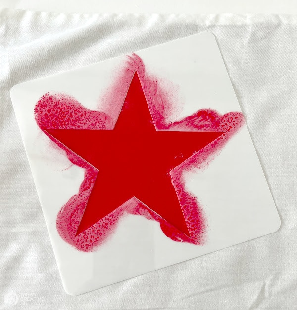 Patriotic Decorating Ideas by making stenciled pillows. Star stencil with red paint