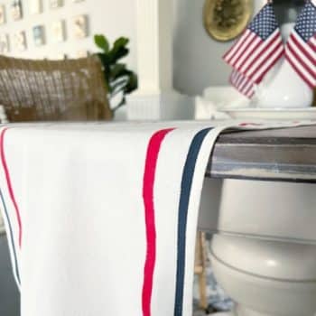 White table runner with red and blue stripes hanging off table