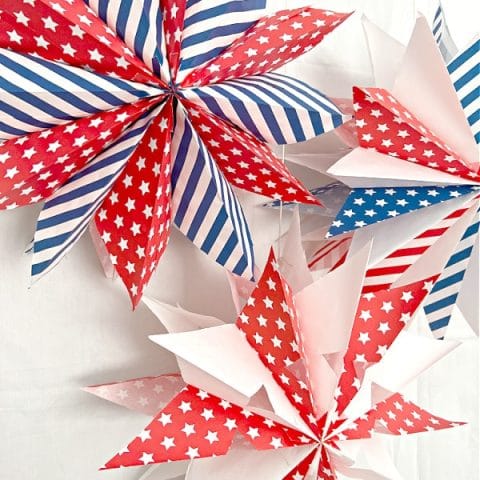 3 paper stars made with red white and blue paper bags.